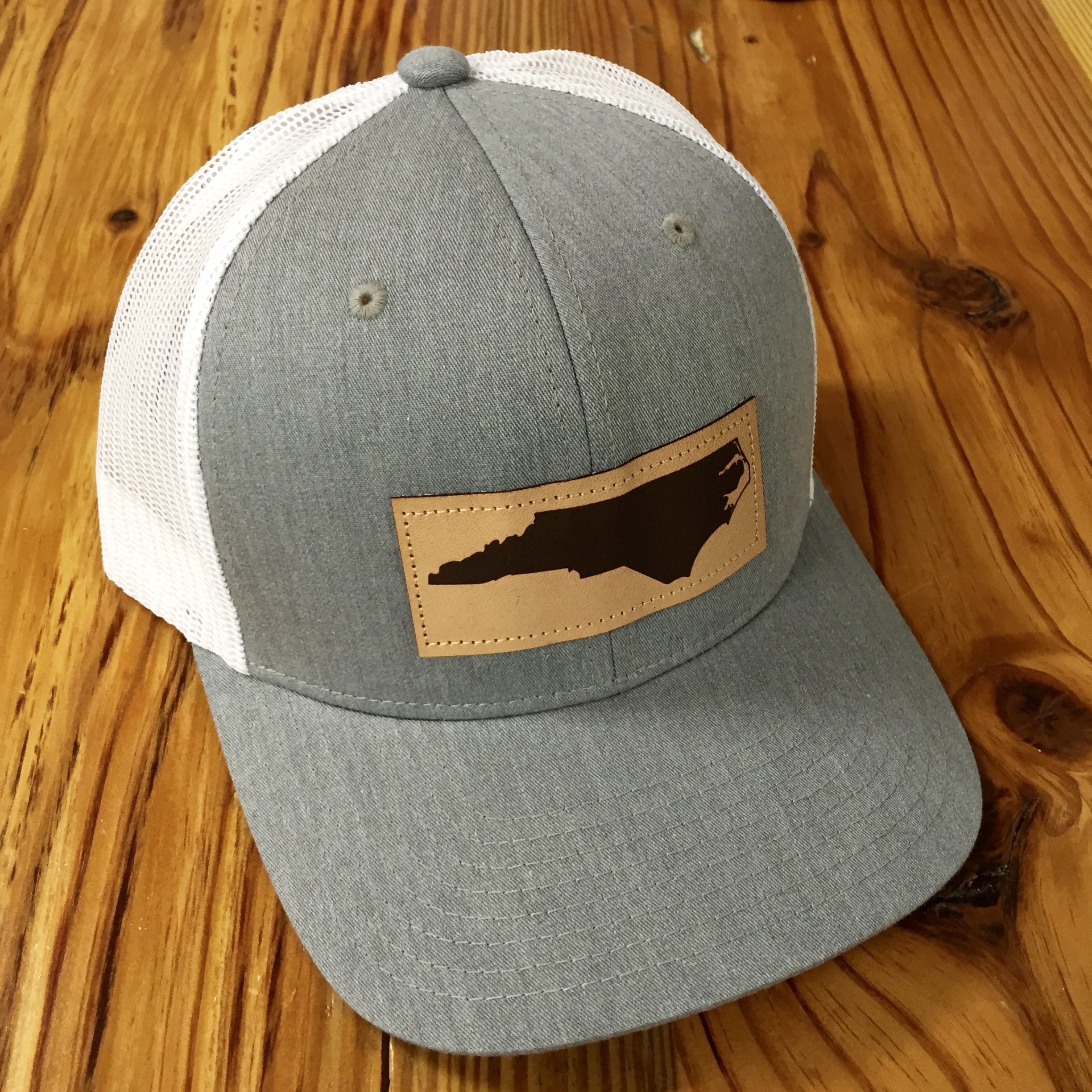 picture North Carolina Leather Patch Hat captuer mesh back north carolina leather patch trucker hat heather grey white